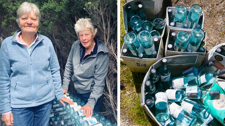 Two women pose with collection of bottles 