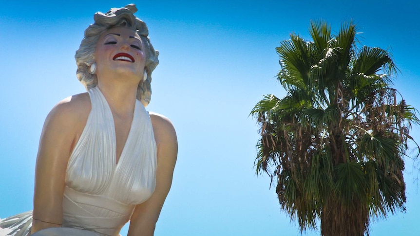 Giant statue of woman in white halter top