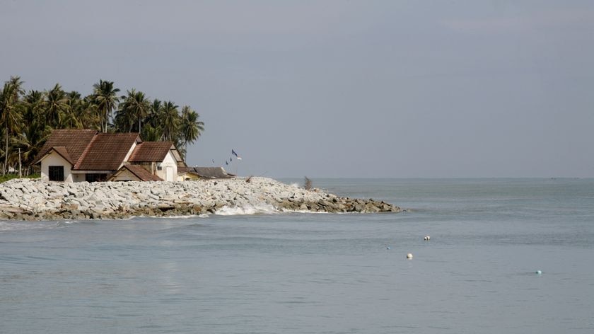 A residence is seen behind an embankment built to prevent erosion in Sabak beach, Malaysia