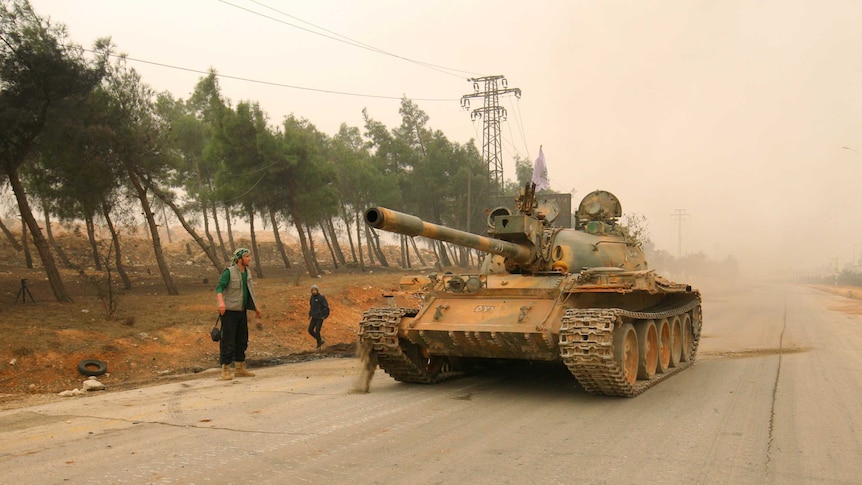 A tank for rebel fighters drives in Dahiyat al-Assad west Aleppo city.