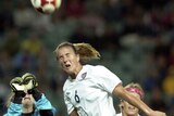 Brandi Chastain of the United States wins a header against Norway at the Sydney Olympics in 2000.