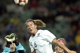 Brandi Chastain of the United States wins a header against Norway at the Sydney Olympics in 2000.