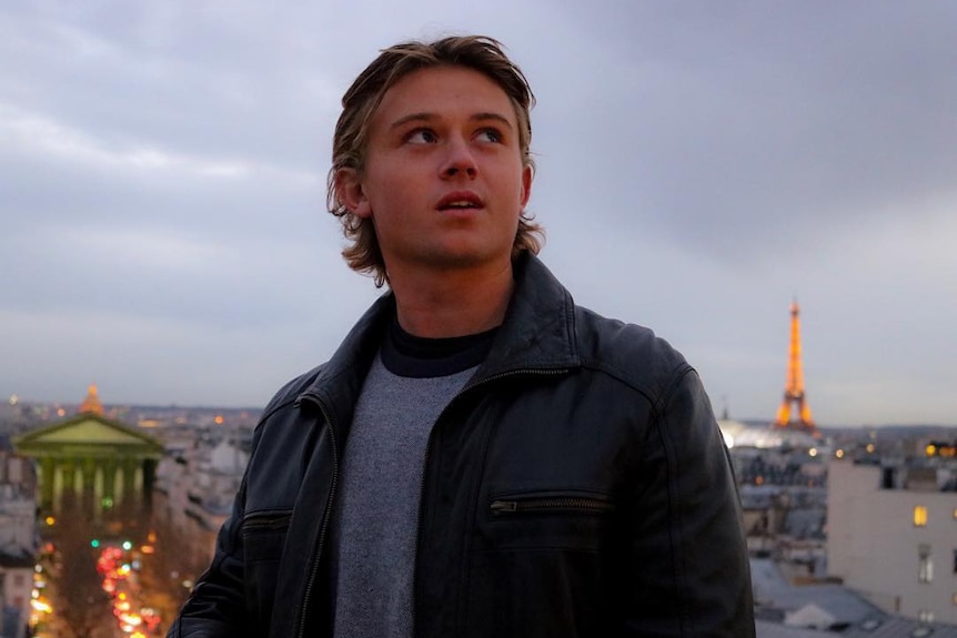 Man looking skyward with Eiffel Tower in background