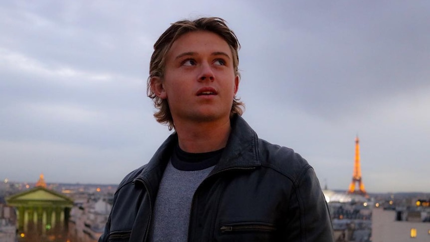 Man looking skyward with Eiffel Tower in background