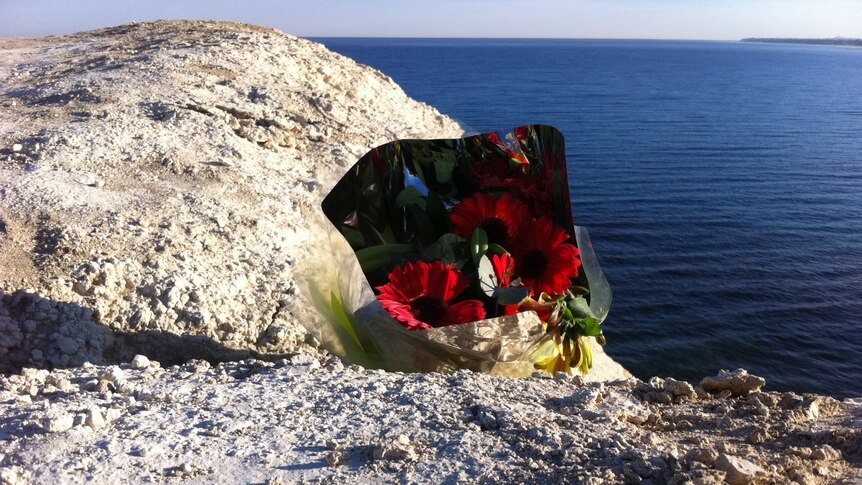 Floral tribute has been left at cliff top