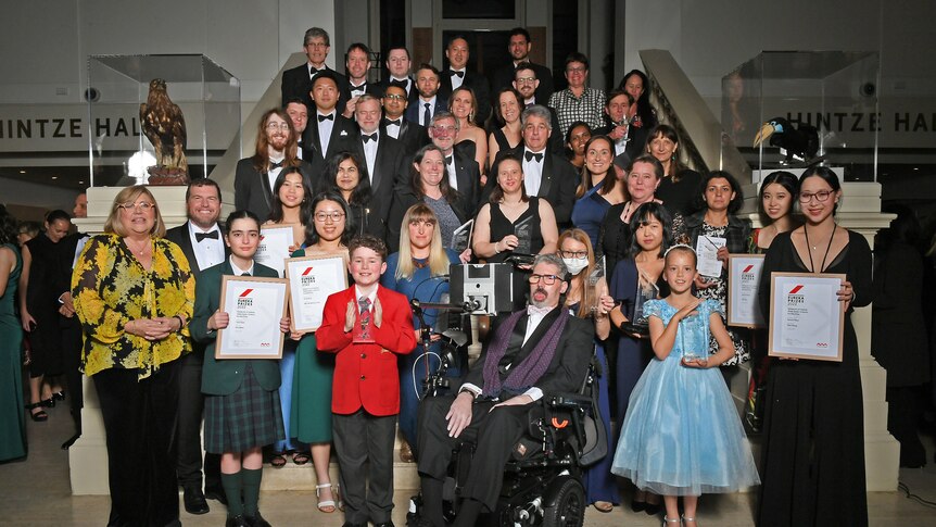 2022 Eureka Prize winners assemble on stairs at The Australian Museum