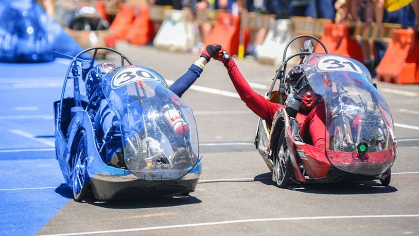 Two electric-powered vehicles at an expo.