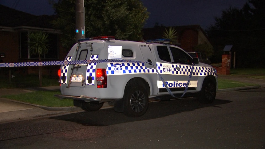 A police vehicle parked in a street at night.