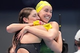 Two Australian swimmers embrace after a world record swim