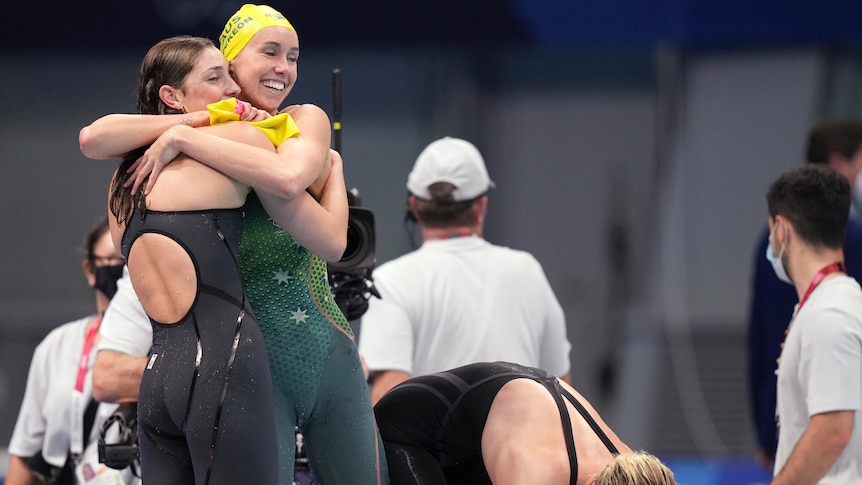 Two Australian swimmers embrace after a world record swim