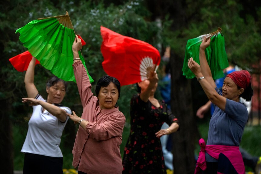 Women dance in a public park in Beijing.