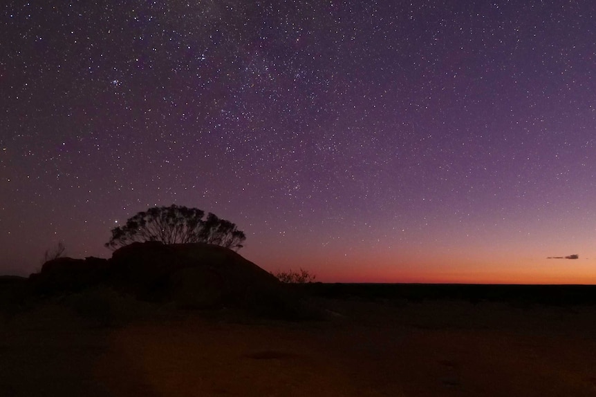 A sunset with stars behind