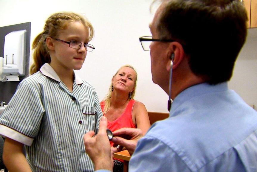 Dr Doug Shelton treats young patient.