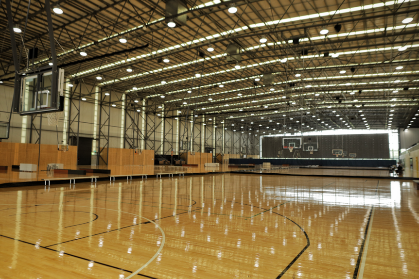 Interior of a sports centre showing a basketball court. 