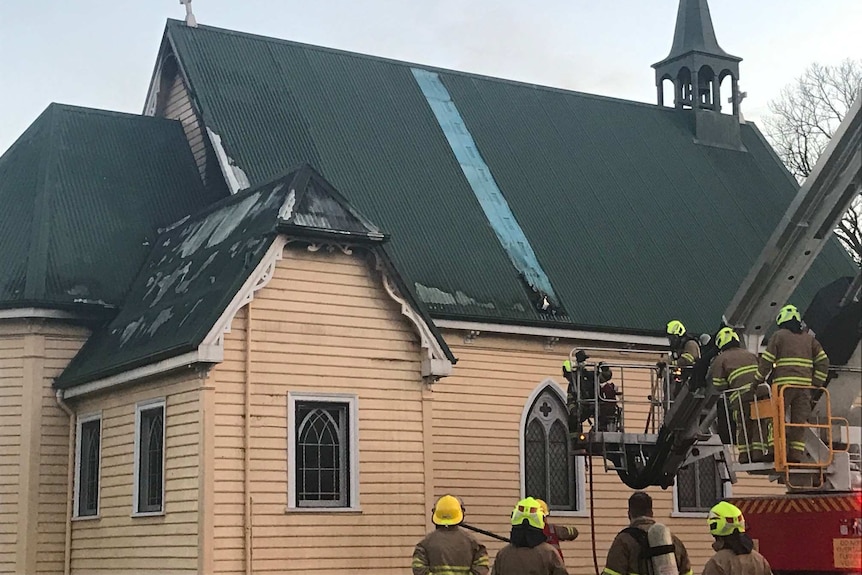 Firefighters putting out a fire in the roof of St Paul's Anglican Church, East Devonport, 9th July 2019