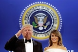 US President Donald Trump salutes with his wife Melania