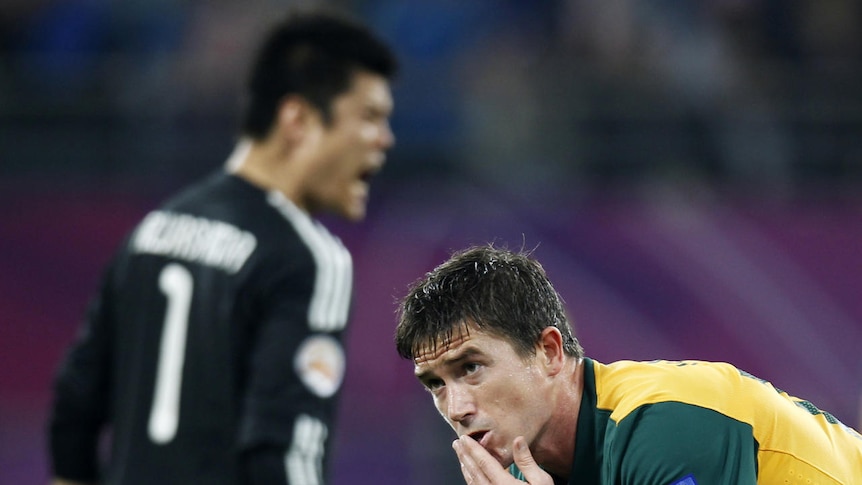 So close: Star forward Harry Kewell rues one of several missed chances in a game Australia perhaps should have won.