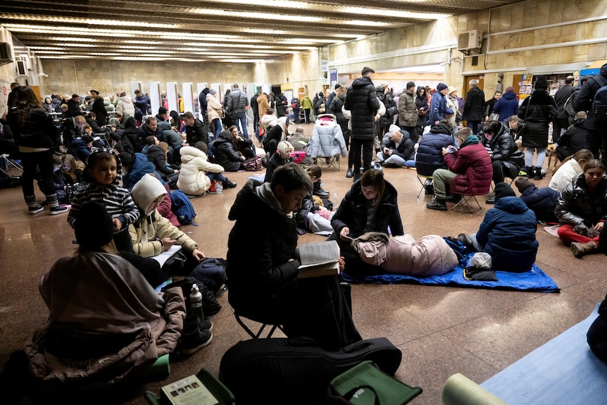 People take shelter at a Kyiv metro station during a Russian air raid.