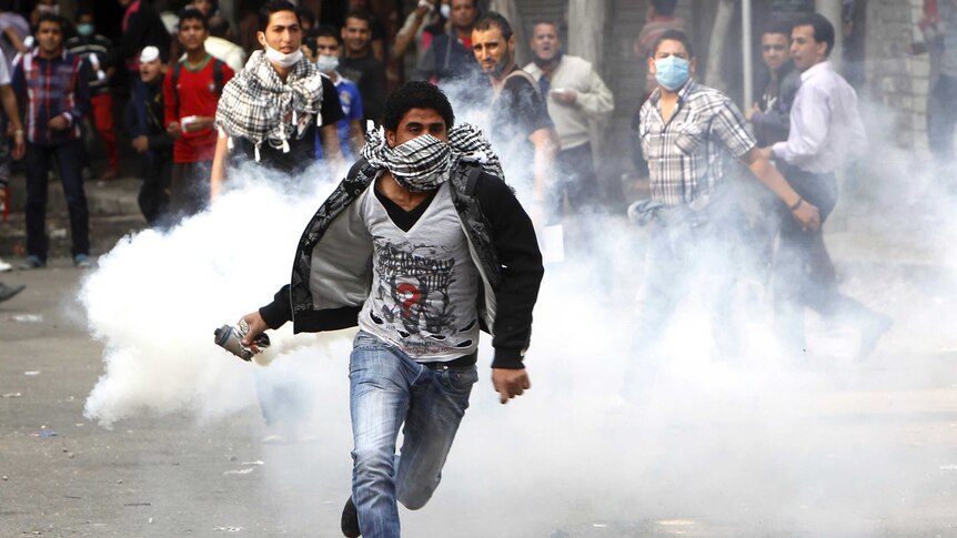 Protester throws back tear gas canister in Egypt