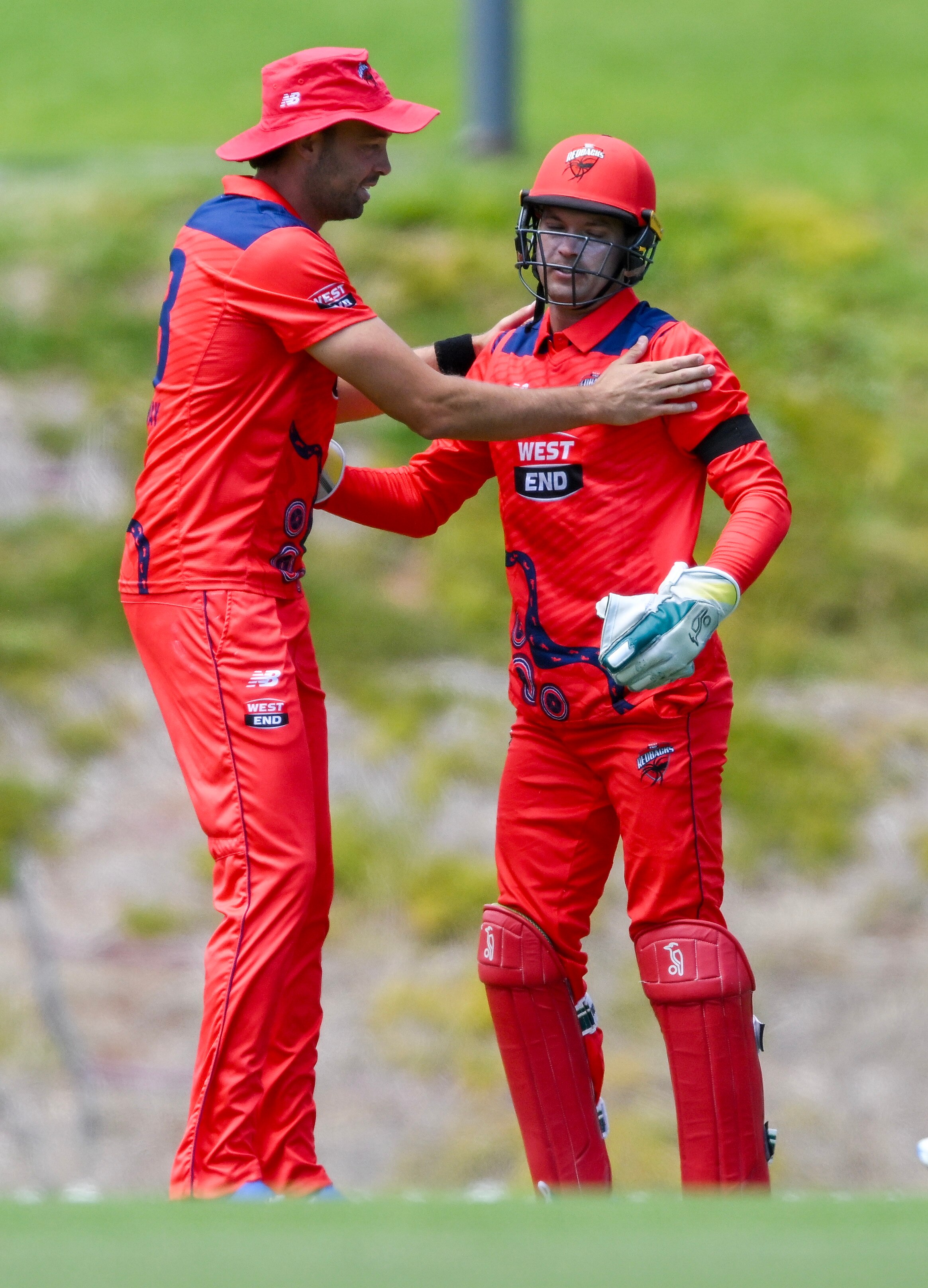 Alex Carey is congratulated by a South Australia teammate after taking a catch.