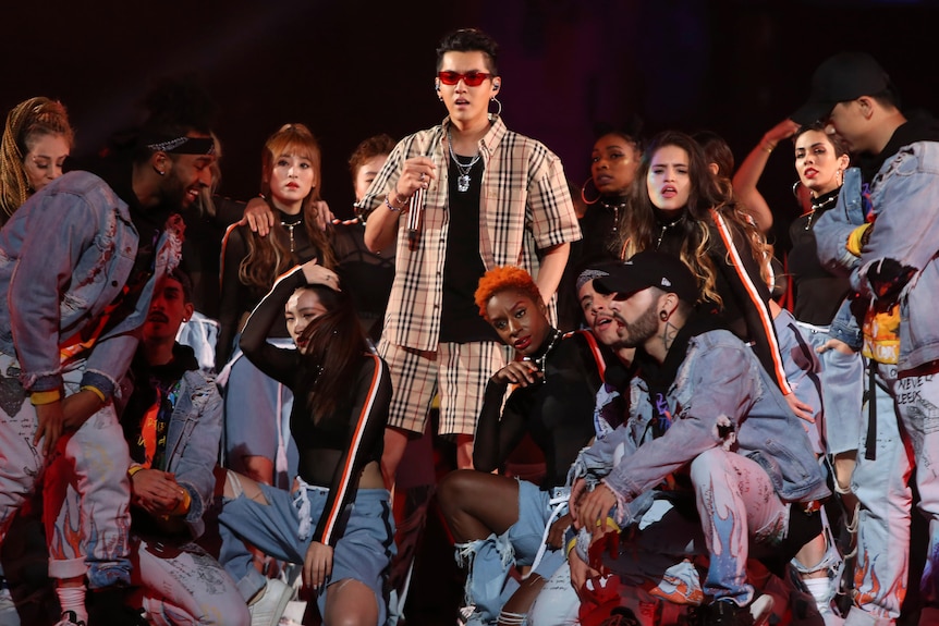 Kris Wu in a Burberry printed shirt and shorts surrounded by backup dancers 