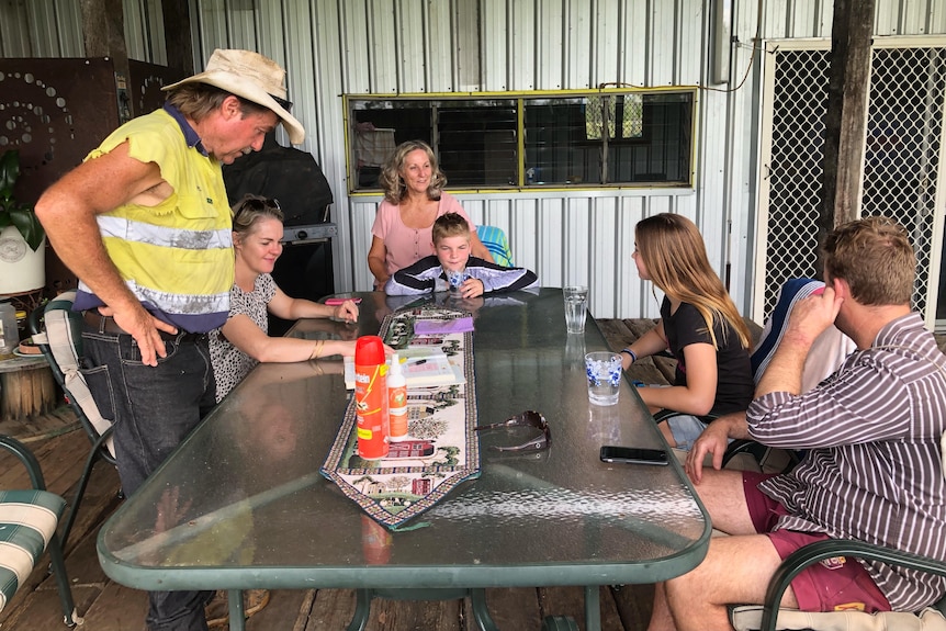 families sitting around an outdoor table