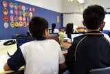 students sitting in a classroom at their desks 