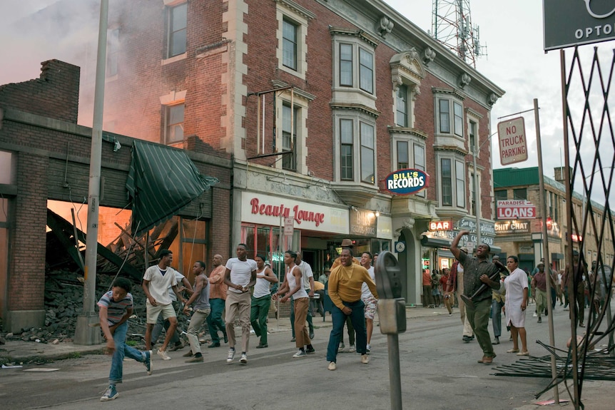 Colour photograph of Detroit rioters re-creating the 12th Street Riot in 1967 in the 2017 film Detroit.