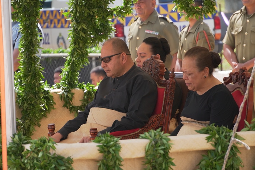 Tongan King and Queen are shown at the funeral procession.