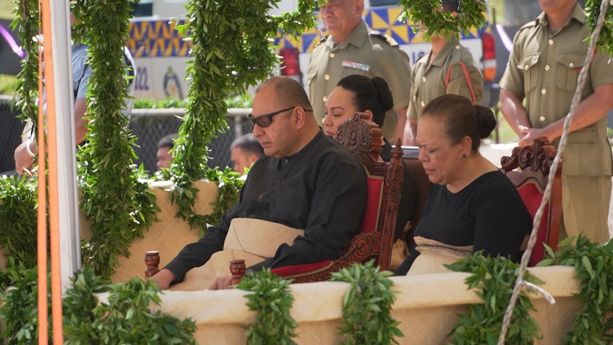 Tongan King and Queen are shown at the funeral procession.