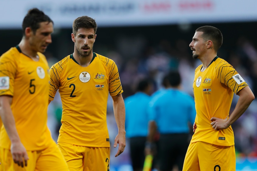 Socceroos players Mark Milligan, Milos Degenek and Jamie Maclaren look forlorn after losing to Jordan