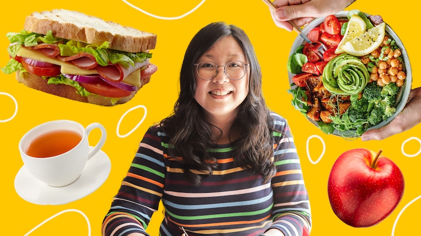 Woman with a cup of tea, sandwich, salad and apple sitting behind her, a story about not eating lunch at your desk.