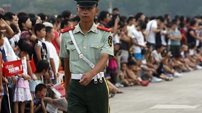 File photo - Policeman and crowd (Reuters)
