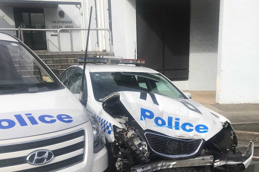 smashed police vehicles outside police station