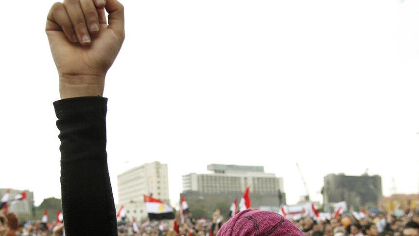 A protester holds back her tears as she chants anti-government slogans during demonstrations at Tahrir Square