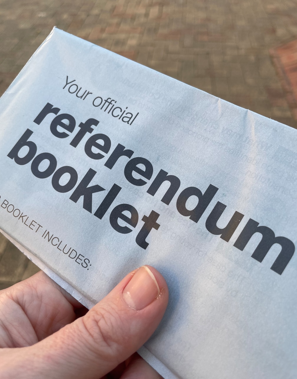 A person holds a Voice to Parliament official referendum booklet