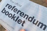 A person holds a Voice to Parliament official referendum booklet
