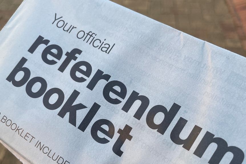 A person holds a Voice to Parliament official referendum booklet