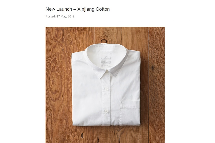 A screenshot of a website showing a picture of a neatly folded white men's button up shirt.