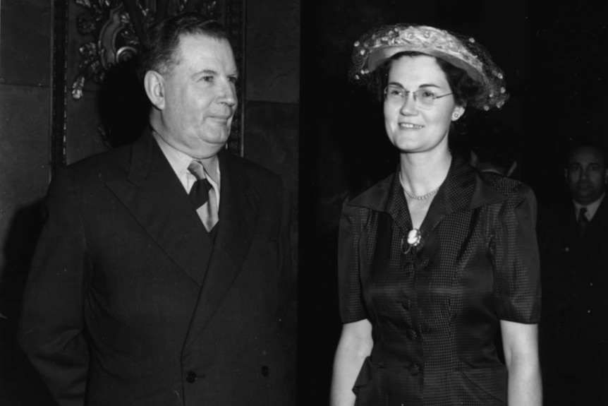 A black and white image of Sir Arthur Fadden with his daughter in 1952. Both are dressed in formal wear.