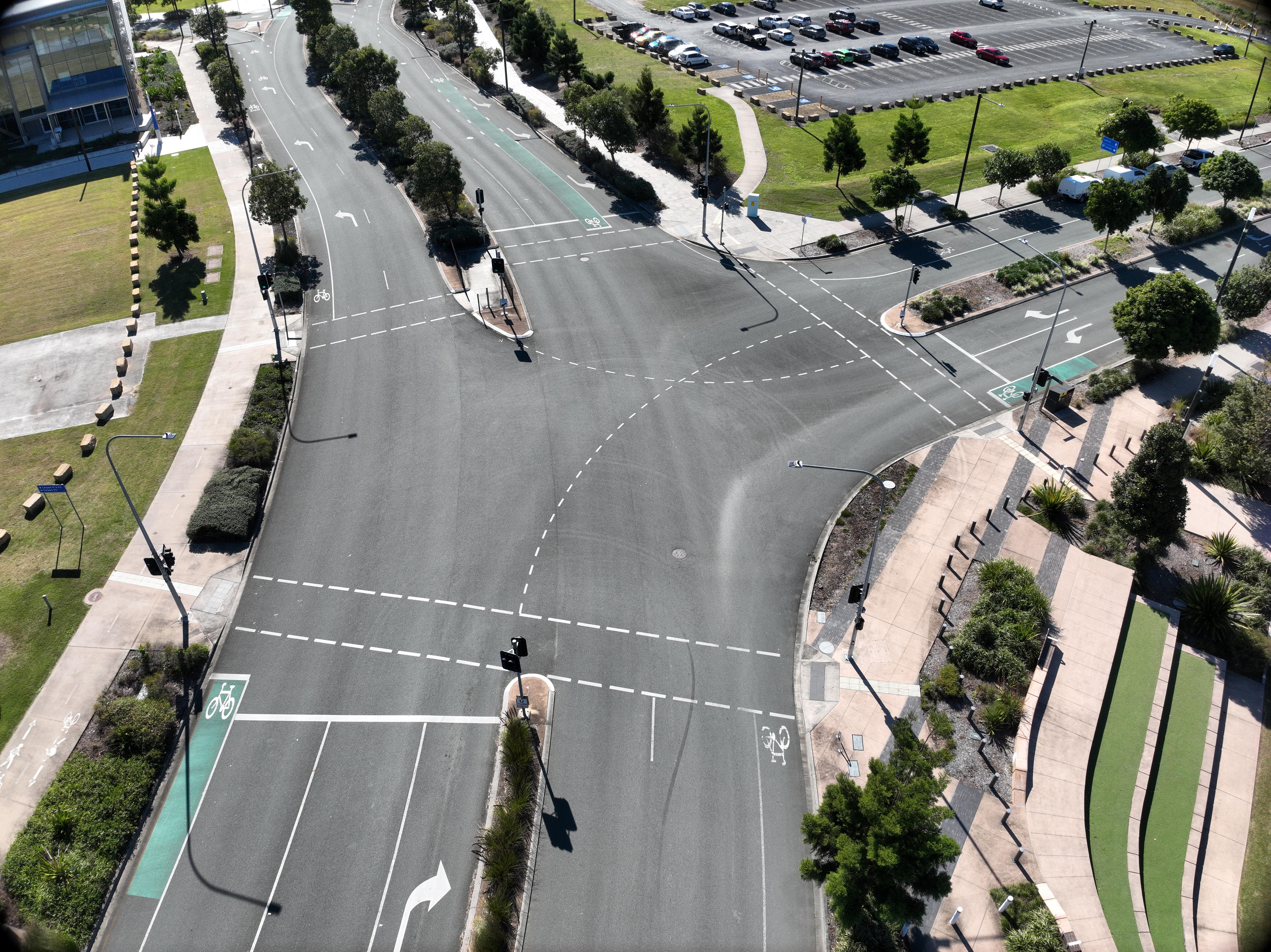 A view from above showing an intersection on a road which has no traffic on it.