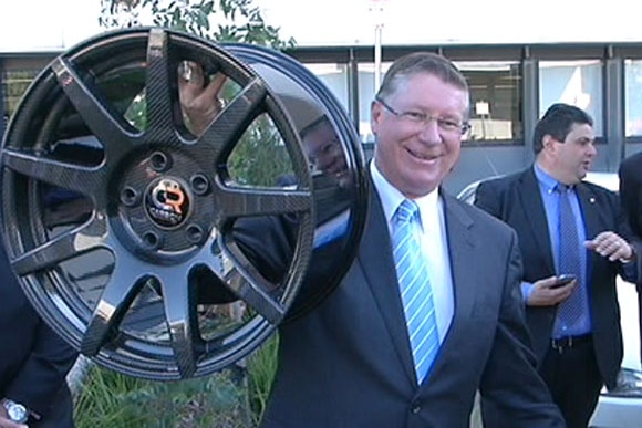 Denis Napthine shows off one of the light-weight carbon fibre wheels