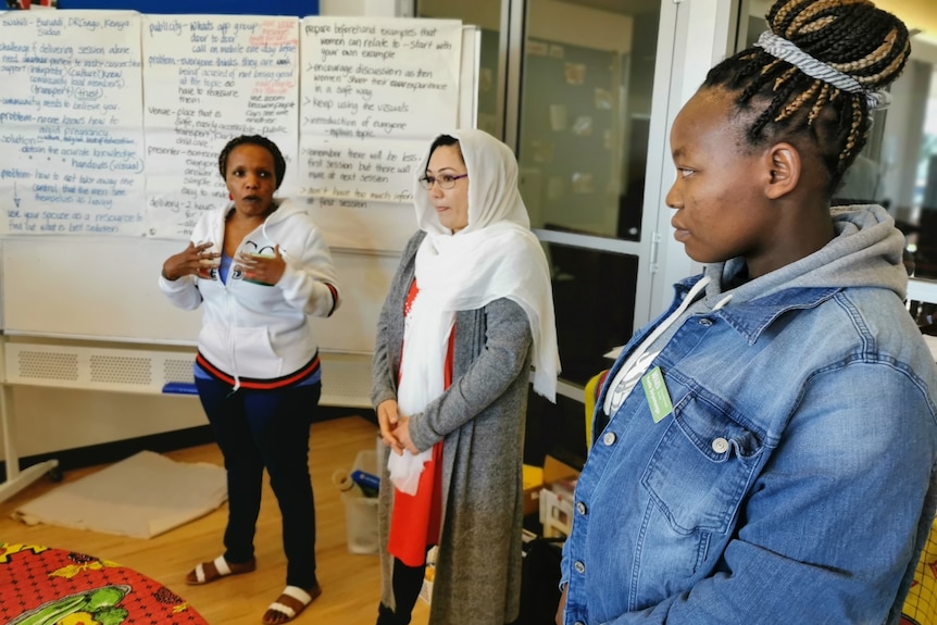 Three women make a presentation