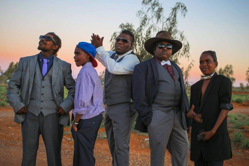 A group of male models pose at the 2017 Kiwirrkurra Fashion Show