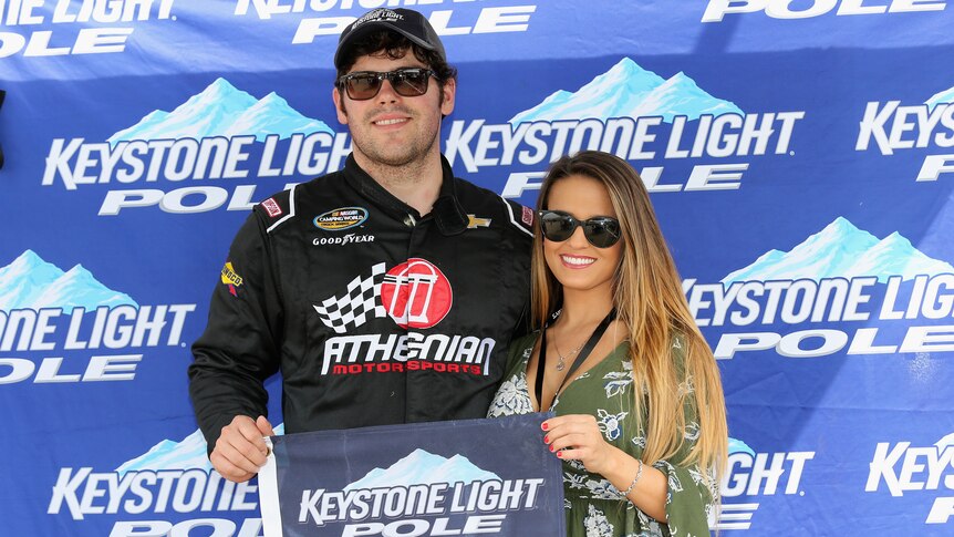 NASCAR driver standing with his ex-wife after winning a race