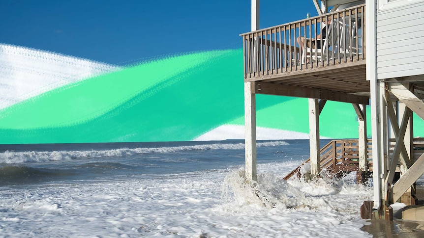 Waves crash underneath a beach-front house for a story about climate risks when buying property.