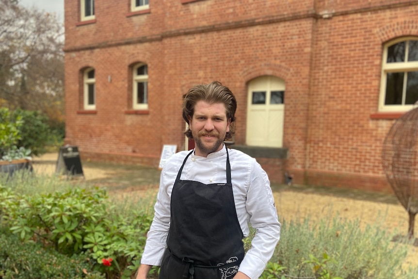 Euroa Butter Factory owner Richard Hayes looks at the camera. He is standing in front of the old brick factory.