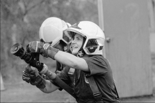 Genevieve Holden holds a fire hose during training