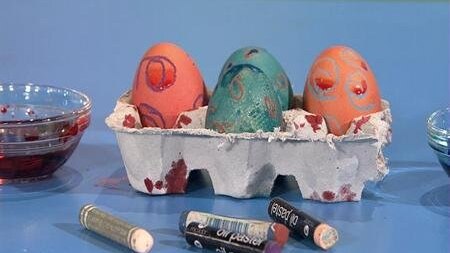 Dyed and decorated eggs in an egg carton