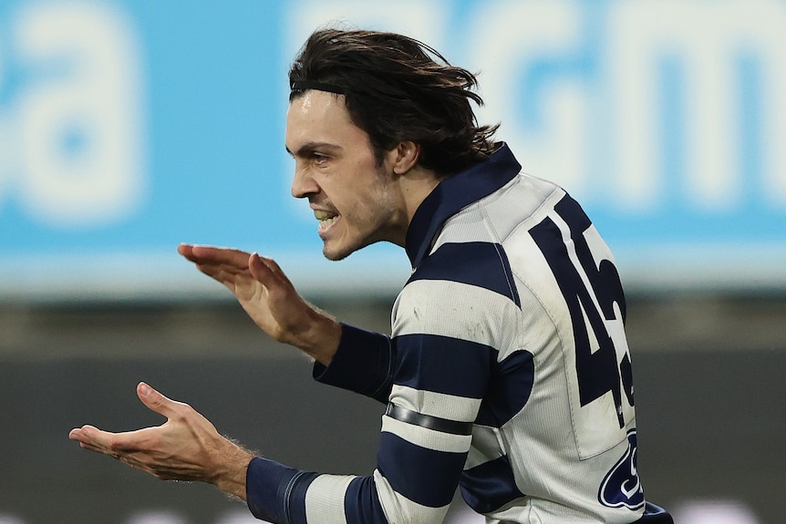 A man celebrates a goal in an AFL match